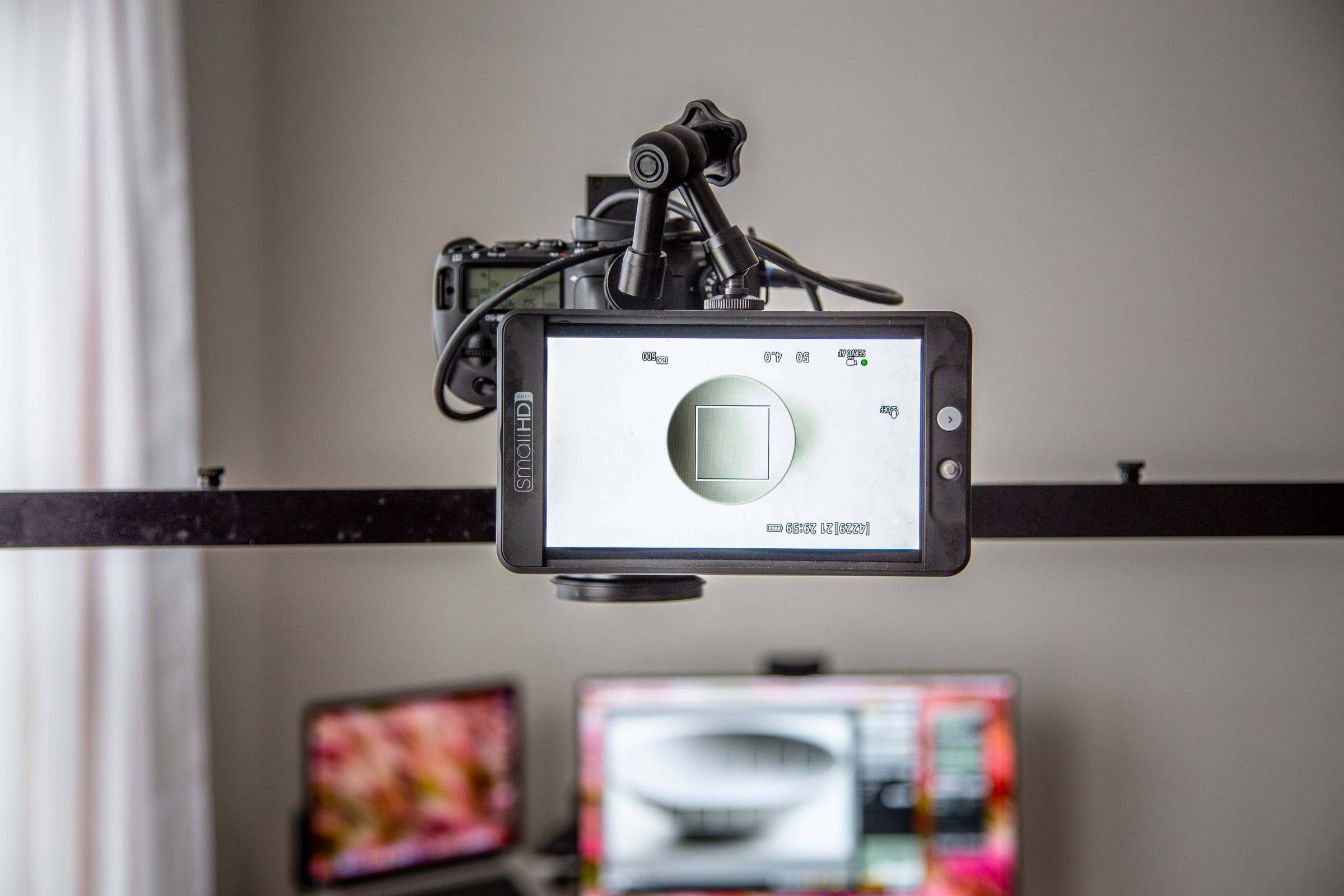 SmallHD monitor connected to DSLR camera on an overhead stand.