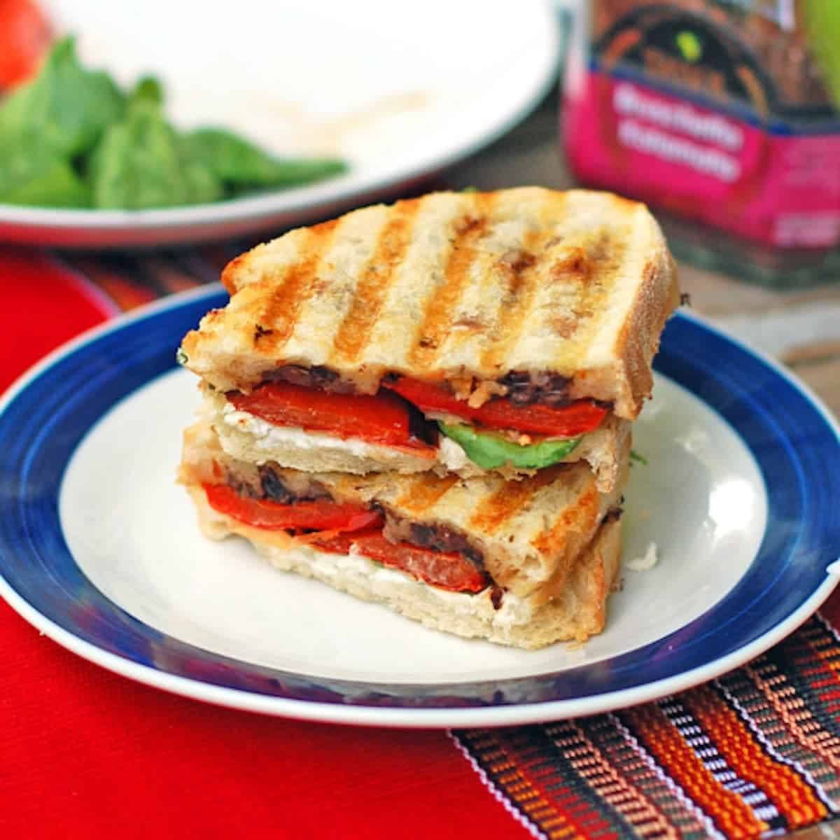 Red pepper and goat cheese panini with a layer of olive tapenade topped with roasted red pepper and soft, creamy goat cheese.