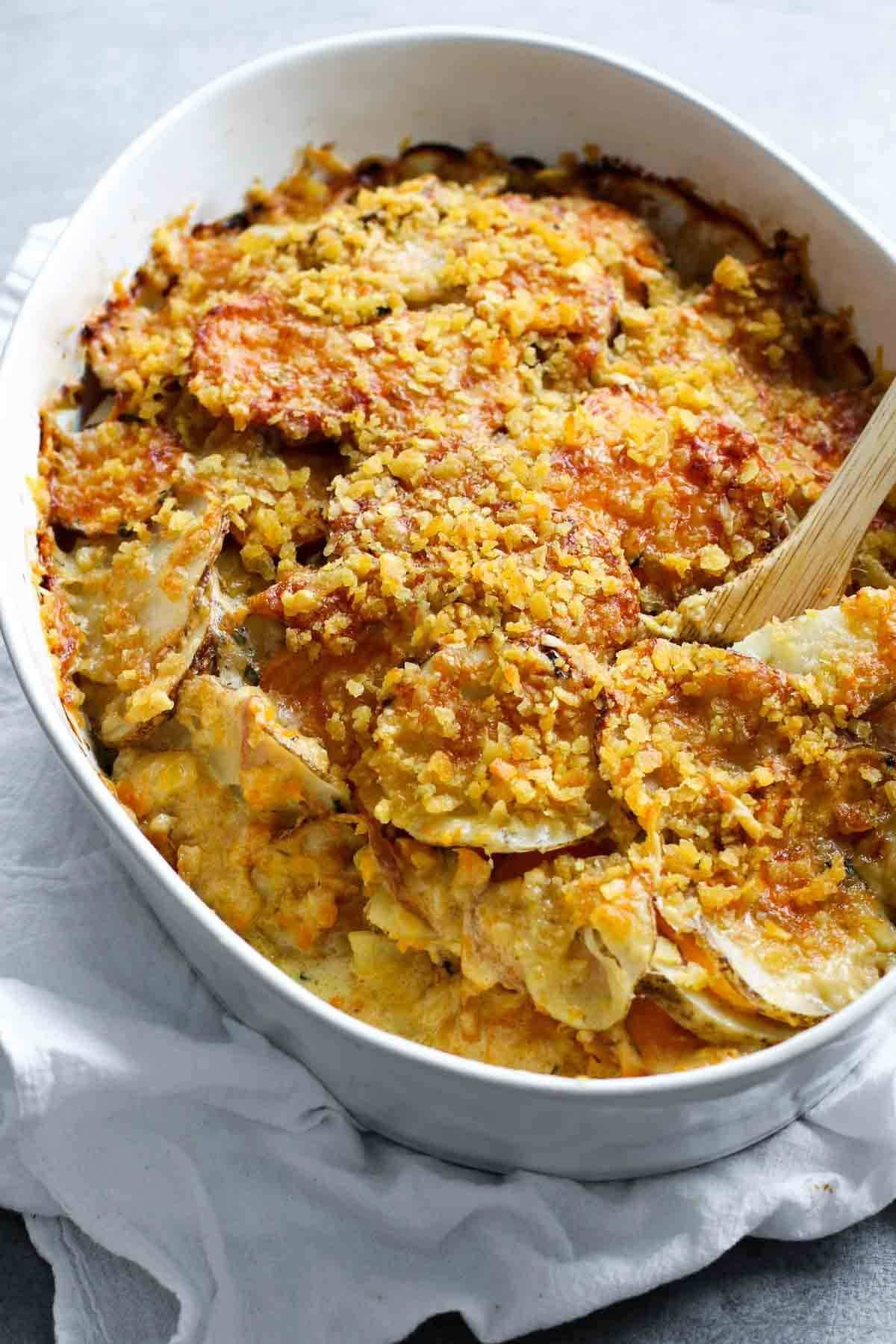 Garlic Herb Cheesy Potatoes in a white baking dish.