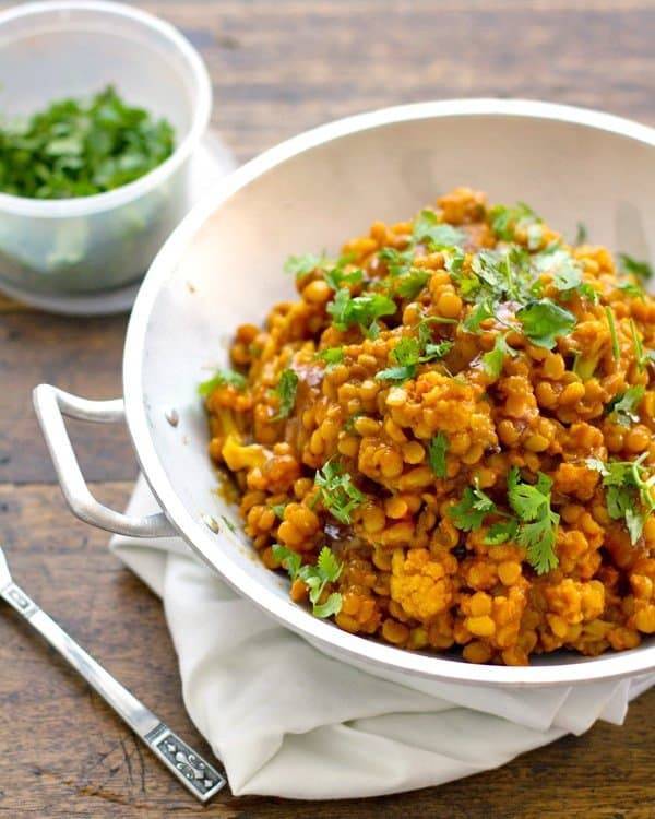 Cauliflower yellow lentil curry in a white dish.
