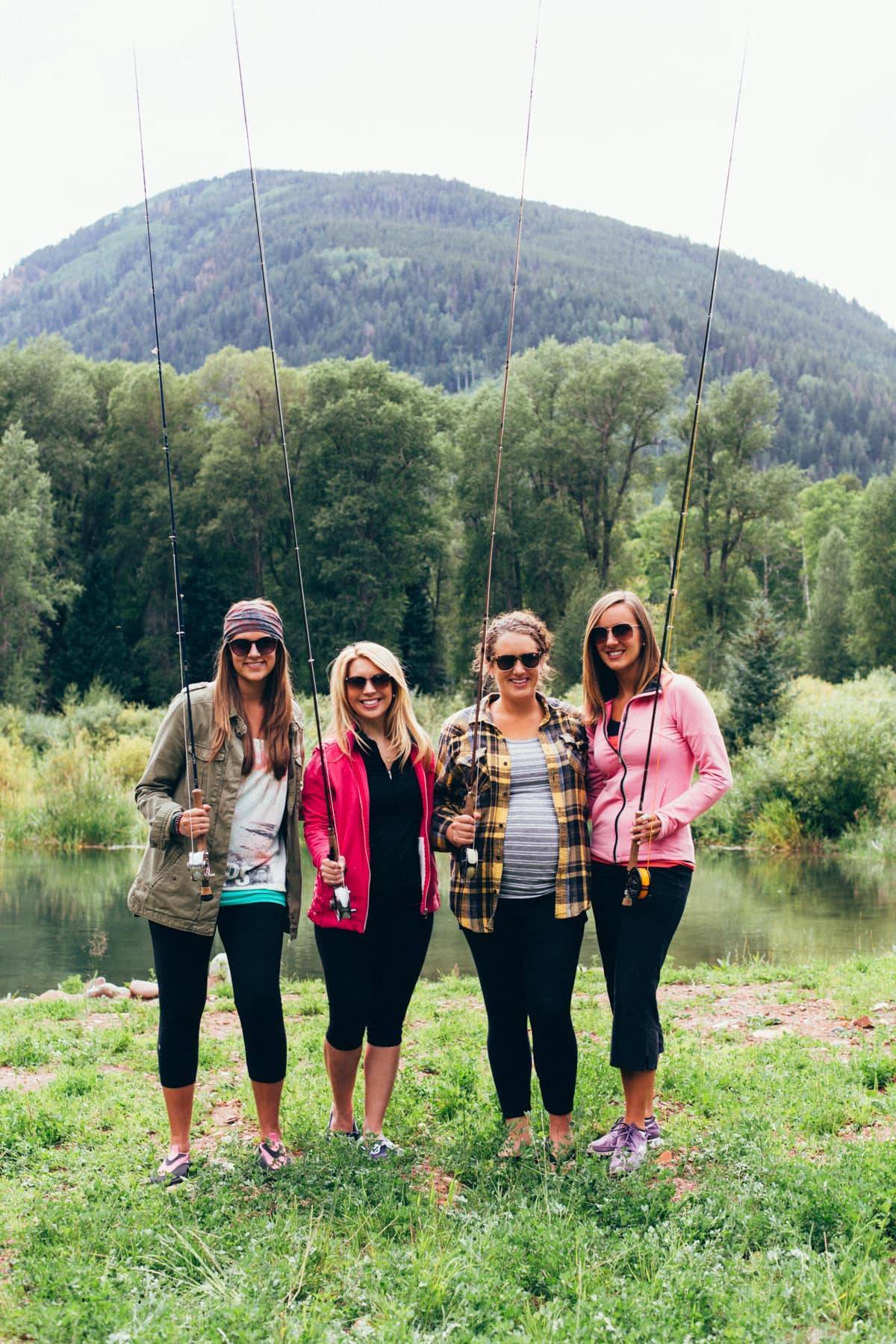Four girls holding fishing poles.
