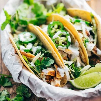 Ancho Chicken Tacos in basket with limes.
