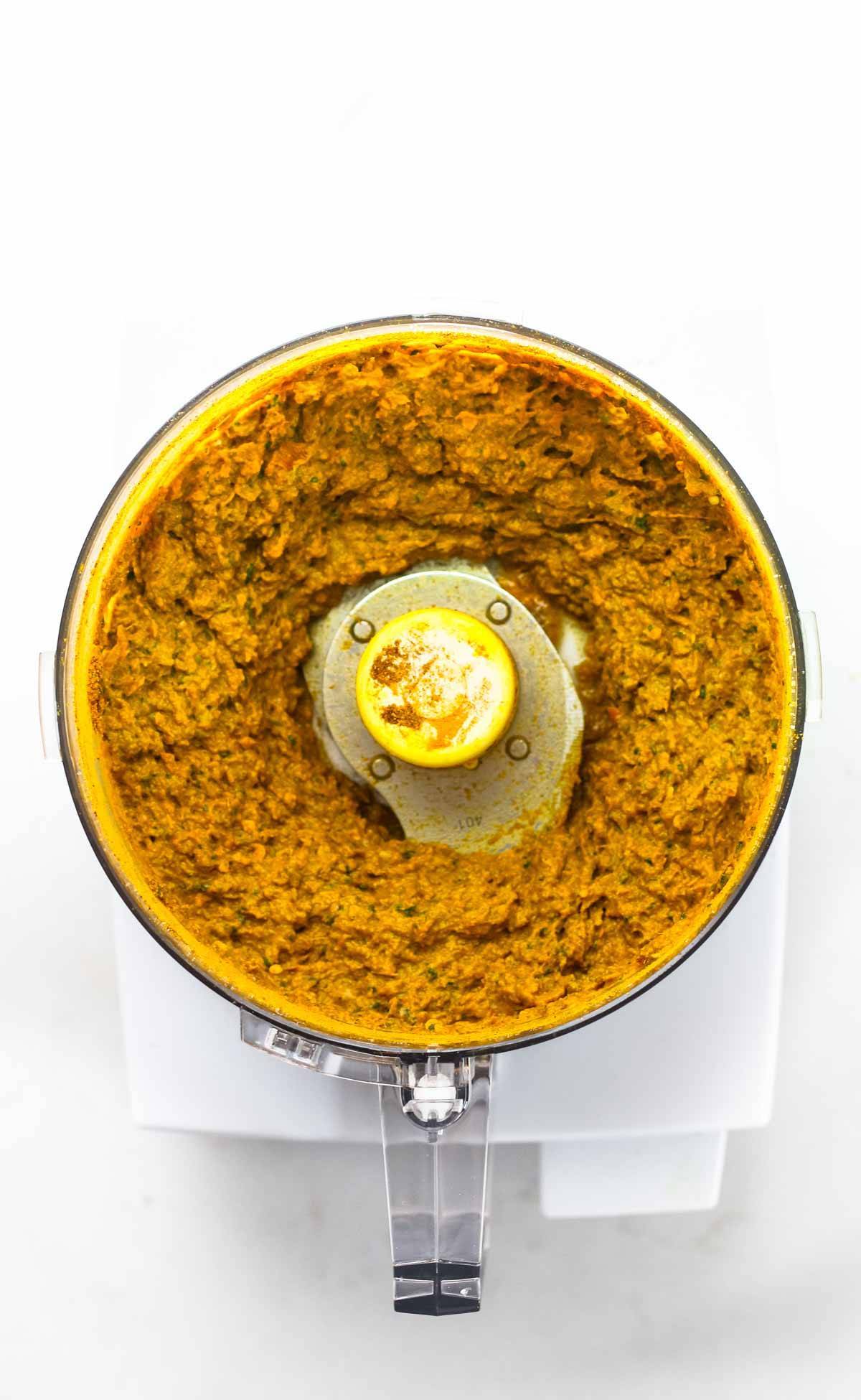 Homemade yellow curry paste blended up in a food processor.