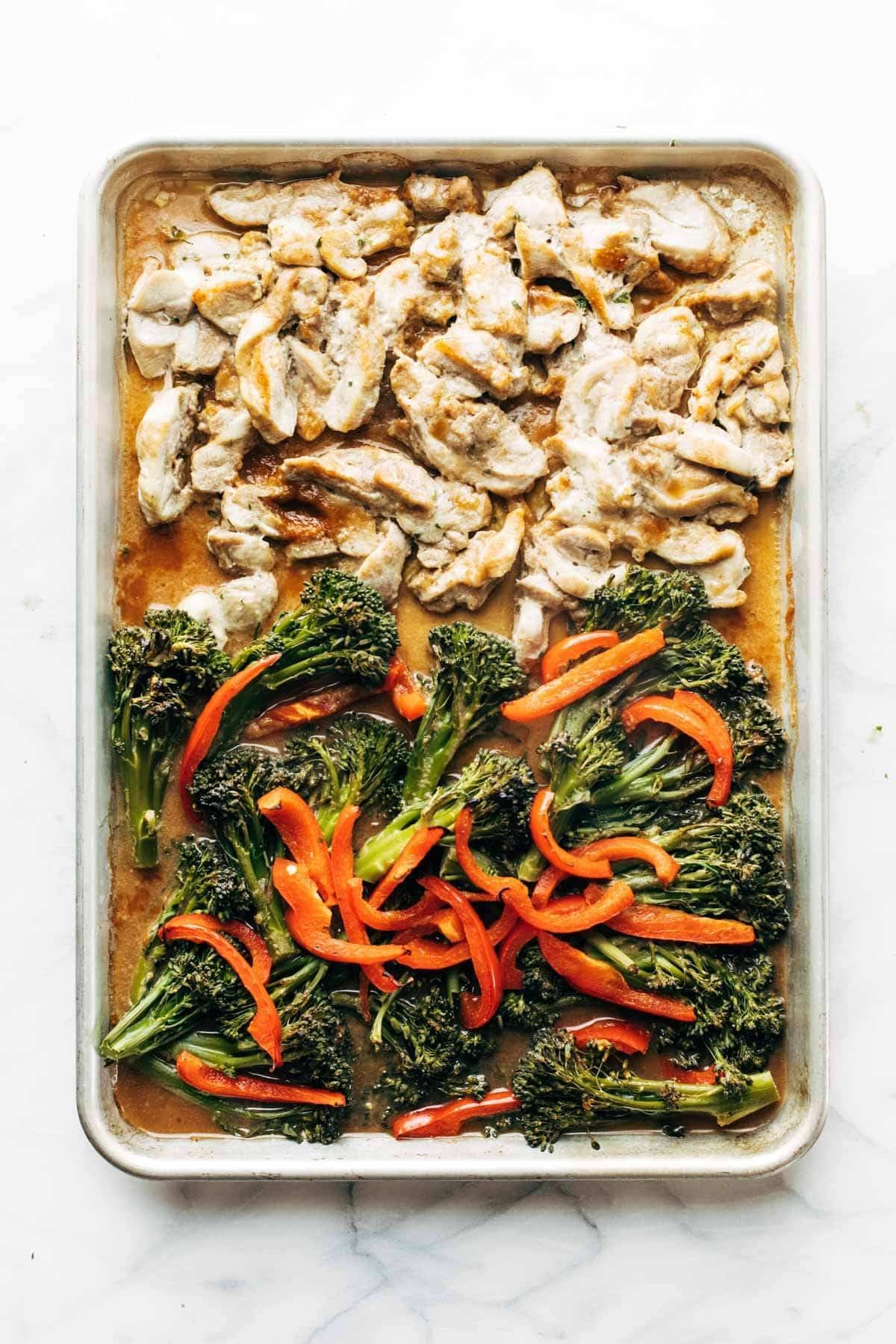 Roasted chicken, broccoli, and peppers on a sheet pan