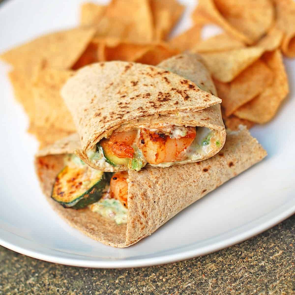 Garlic shrimp and zucchini wrap on a whole wheat tortilla with grilled zucchini.