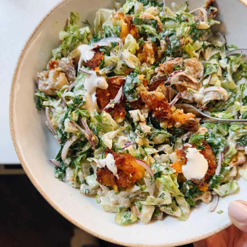 Crispy smashed potato salad in a bowl.